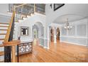 Spacious foyer featuring hardwood floors, decorative moldings, and arched entryways, creating an inviting atmosphere at 9112 Butterfly Ct, Gastonia, NC 28056