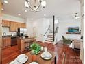 Open-concept living space with kitchen, dining, and living room featuring hardwood floors at 956 Warren Burgess Ln, Charlotte, NC 28205