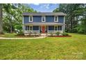 Charming two-story home with a welcoming front porch and well-manicured lawn at 9929 Kerns Rd, Huntersville, NC 28078