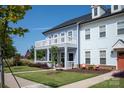 Charming two-story home with a covered front porch, second floor deck, manicured lawn, and seating area at 1100 Herrons Ferry Rd, Rock Hill, SC 29730