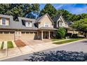 A street view of the residential building showing the garage, covered front porch, and well maintained landscaping at 128 Aztec Cir, Mooresville, NC 28117