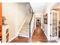 Welcoming foyer with hardwood floors, staircase, and a view into the living room at 128 Aztec Cir, Mooresville, NC 28117