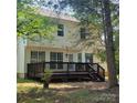 A two-story home with a backyard deck, perfect for outdoor entertaining and relaxation at 13039 Peacock Ln, Charlotte, NC 28215