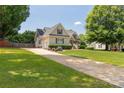 Attractive home featuring manicured lawn and a long drive leading to a side-entry garage at 1530 Danlee Dr, Lancaster, SC 29720