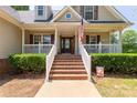 Welcoming front porch with brick steps and white railing, featuring seasonal decorations at 1530 Danlee Dr, Lancaster, SC 29720