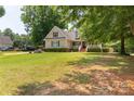 Charming two-story home with a well-manicured lawn, mature trees, and inviting front porch at 1530 Danlee Dr, Lancaster, SC 29720