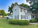 Well-maintained two-story home showcasing clean white siding and well-maintained landscaping on the large front yard at 156 Spruce St, Badin, NC 28009