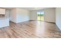 Bright living room with hardwood floors, a sliding glass door, and white walls at 157 Astor St, Troutman, NC 28166