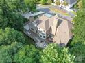 Aerial view of the home showcasing the outdoor living space, rear deck, and lush tree surround at 15708 Eagleview Dr, Charlotte, NC 28278