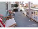 Cozy front porch with comfortable seating, perfect for relaxing and enjoying the neighborhood views at 15907 Rose Glenn Ln, Davidson, NC 28036