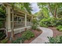 Inviting front porch with stone walkway, detailed trim work, and lush landscaping for serene outdoor living at 1701 Truman Rd, Charlotte, NC 28205