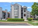Well-maintained condominium with a gray facade and manicured landscaping at 18853 Vineyard Point Ln, Cornelius, NC 28031