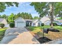 Beautiful home with a manicured lawn and a driveway leading to an attached one car garage at 1922 Decatur Ct, Charlotte, NC 28213