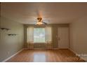 Bright living room with ample natural light, wood floors, and neutral walls creating a welcoming space at 214 Cottage Pl, York, SC 29745