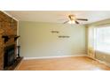 Comfortable living room with a fireplace and wood floors, great for relaxing and entertaining guests at 214 Cottage Pl, York, SC 29745
