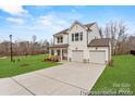 Beautiful exterior view of a two story house with two car garage and modern curb appeal at 219 Redondo Dr # 65, Wingate, NC 28174