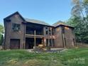 Brick home featuring a second-story deck with large windows at 2341 Shiny Leaf Dr, Denver, NC 28037