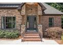 Inviting home entrance with brick steps, stone accents, and a stylish front door with sidelights at 2341 Shiny Leaf Dr, Denver, NC 28037
