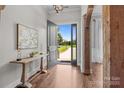 Bright foyer with wood floors, decorative table, and an exterior view at 2341 Shiny Leaf Dr, Denver, NC 28037