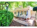 Inviting front porch with chairs and colorful flower beds leading to the home's entrance, adding curb appeal at 3043 Charles Rd, Shelby, NC 28152