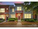 Beautiful brick townhome with manicured landscaping and a serene setting during twilight at 3153 Bending Birch Pl, Charlotte, NC 28206