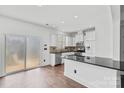 Modern white kitchen featuring stainless steel appliances, a granite countertop, and ample cabinet space at 3153 Bending Birch Pl, Charlotte, NC 28206