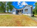 Home exterior with a blue siding and a well-manicured lawn and driveway at 338 Hollingswood Dr, Statesville, NC 28625