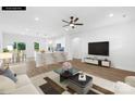 Bright living room open to kitchen, with hardwood floors, white walls, and ample natural light at 338 Hollingswood Dr, Statesville, NC 28625