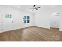 Room with hardwood floors, ceiling fan, one window, and a white door at 338 Hollingswood Dr, Statesville, NC 28625