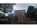 Home's back exterior features a deck, patio area and multi-toned brick at 4227 Kiser Woods Sw Dr, Concord, NC 28025