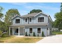 Two-story home boasts light blue siding, white trim, a garage, and a cozy front porch at 428 Clay St, Mooresville, NC 28115