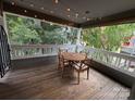 Cozy patio features a wooden table, four chairs with cushions, and ambient string lights overhead at 433 W 8Th Street St, Charlotte, NC 28202