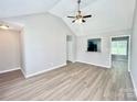 Bright living room featuring vaulted ceilings, wood-look floors, and ample natural light at 5800 Silver Eagle Dr, Charlotte, NC 28214