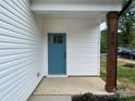 Inviting entry to this new home featuring a modern blue door and craftsman details at 619 Billingsley Rd, Charlotte, NC 28211