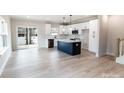 Modern kitchen with white cabinets, stainless steel appliances, and center island at 619 Billingsley Rd, Charlotte, NC 28211