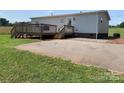 View of the home's spacious back deck and paved area, offering ample space for outdoor relaxation and entertainment at 6219 Heavner Rd, Vale, NC 28168