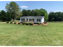 Beautiful curb appeal of this well-maintained home and landscaped yard, showcasing its charm and inviting atmosphere at 6219 Heavner Rd, Vale, NC 28168