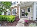 Charming townhome entrance featuring an inviting front porch with stylish decor and well-manicured landscaping at 635 Brickdust Ct, Fort Mill, SC 29708
