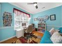Bright office with hardwood floors, large window, and cheerful blue walls at 635 Brickdust Ct, Fort Mill, SC 29708