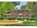 Charming two-story brick home featuring mature landscaping and black window shutters at 6434 Sardis Rd, Charlotte, NC 28270