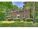 Charming two-story brick home featuring mature landscaping and black window shutters at 6434 Sardis Rd, Charlotte, NC 28270