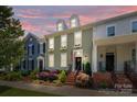 Charming townhome at dusk with landscaped front yard, brick stairs, and classic architectural details at 6438 Hove Rd, Mint Hill, NC 28227
