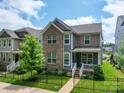 Two-story home features blue and brown siding, fenced yard, and well-maintained landscaping at 647 R L Stowe Rd, Belmont, NC 28012