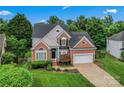 An inviting two-story home with lush greenery, a two-car garage, and a well-kept lawn at 6632 Hawksnest Dr, Charlotte, NC 28269
