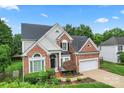 Beautiful two-story home featuring brick accents, a two-car garage, and manicured landscaping at 6632 Hawksnest Dr, Charlotte, NC 28269