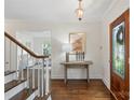 Inviting foyer with hardwood floors, stylish lighting, and a decorative entry table at 7213 Lancer Dr, Charlotte, NC 28226