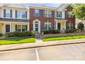 Well-maintained townhome exterior with brick facade, blue shutters, and landscaped front yard at 7881 Mariners Pointe Cir, Denver, NC 28037