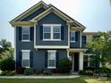 Inviting two-story home featuring a well-manicured lawn, complemented by vibrant shrubs and beautiful blooming flowers at 8340 Breton Way, Harrisburg, NC 28075