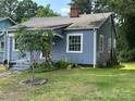 The house features a well-maintained lawn and mature trees, showcasing its inviting outdoor space at 839 S Chester St, Gastonia, NC 28052