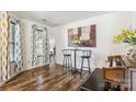 Dining area features decorative artwork, elegant furnishings, attractive curtains and hardwood flooring at 925 Skywatch Ln, Monroe, NC 28112